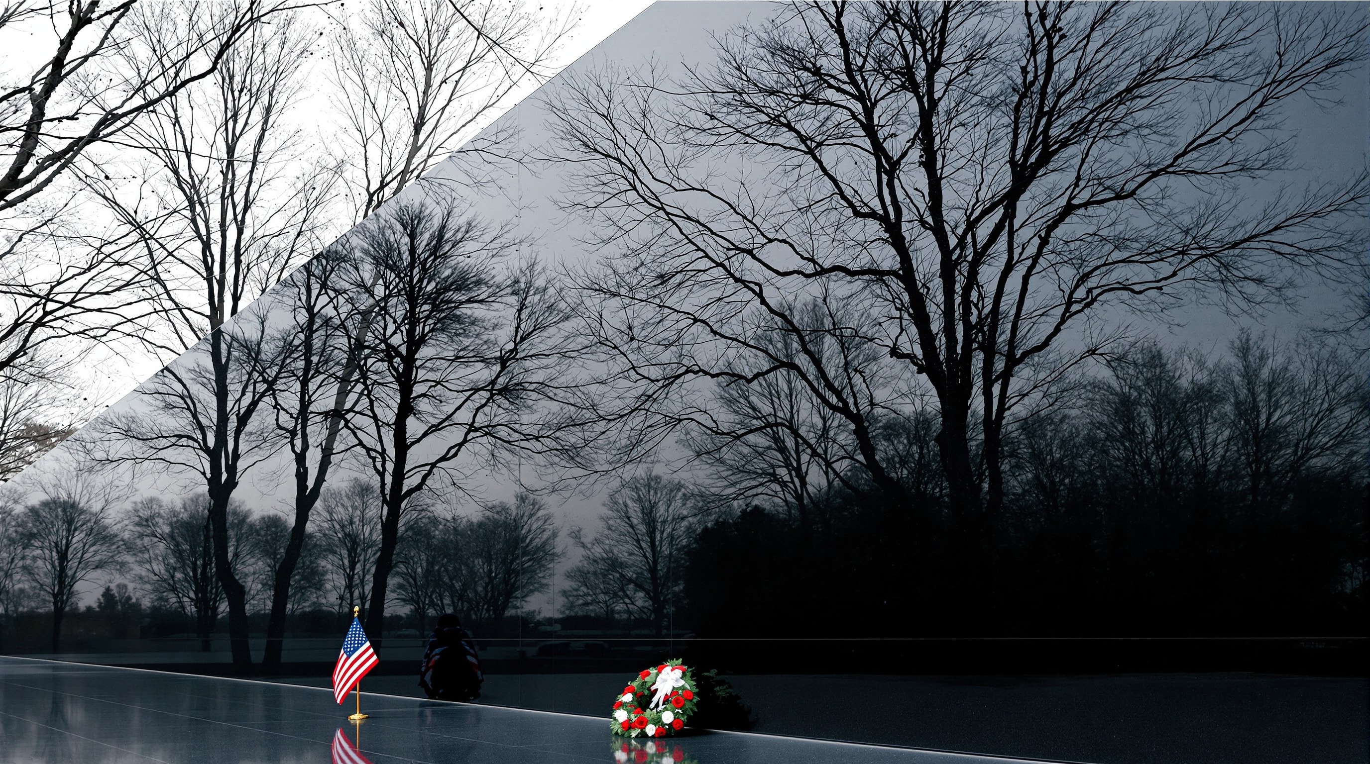 A polished granite memorial wall with a wreath and small flag